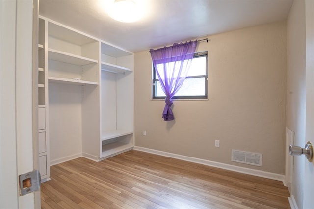 unfurnished bedroom with light wood-style floors, a closet, visible vents, and baseboards