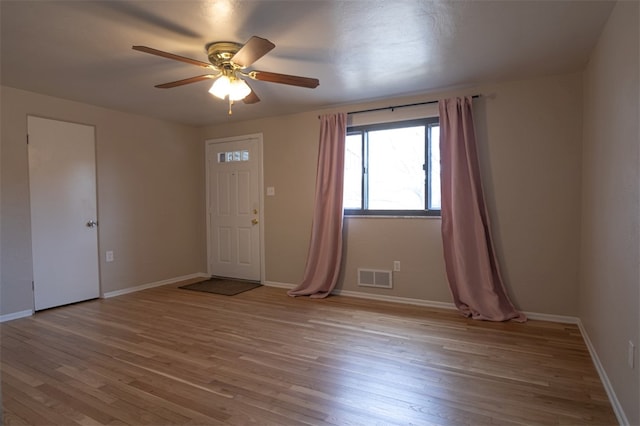 interior space featuring baseboards, visible vents, and wood finished floors