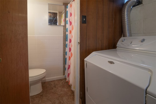 washroom featuring washer / dryer and tile walls