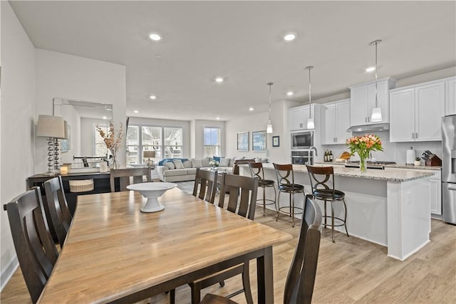 dining room featuring light wood finished floors and recessed lighting