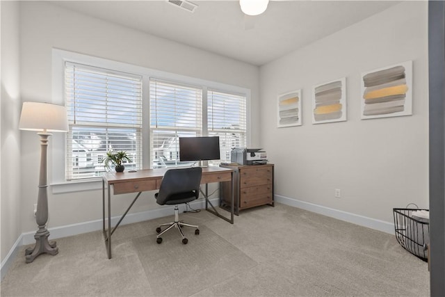 carpeted home office featuring visible vents, plenty of natural light, and baseboards