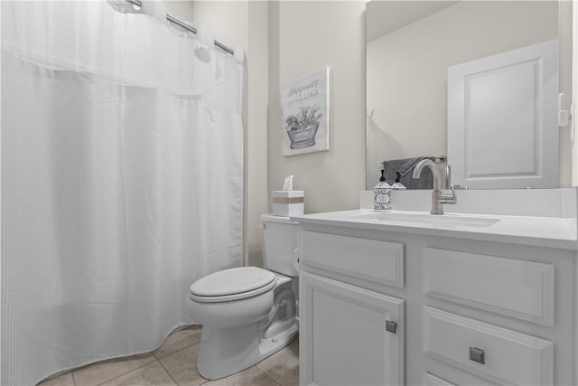 bathroom featuring toilet, curtained shower, tile patterned flooring, and vanity