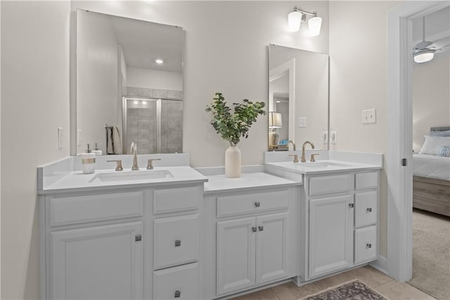 ensuite bathroom featuring double vanity, ensuite bath, a sink, and a stall shower