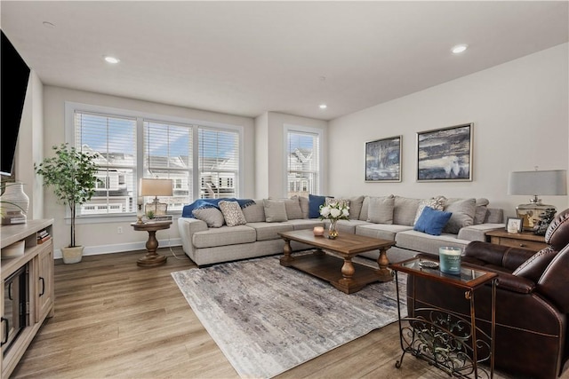 living area featuring light wood-type flooring, baseboards, and recessed lighting