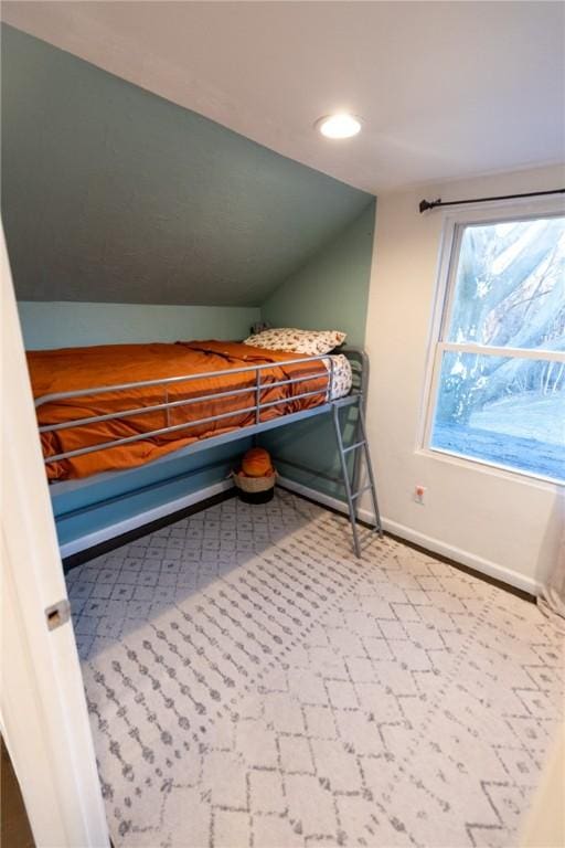 unfurnished bedroom featuring recessed lighting, vaulted ceiling, and baseboards