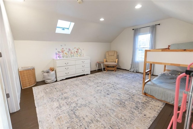 bedroom featuring vaulted ceiling with skylight, wood finished floors, and recessed lighting