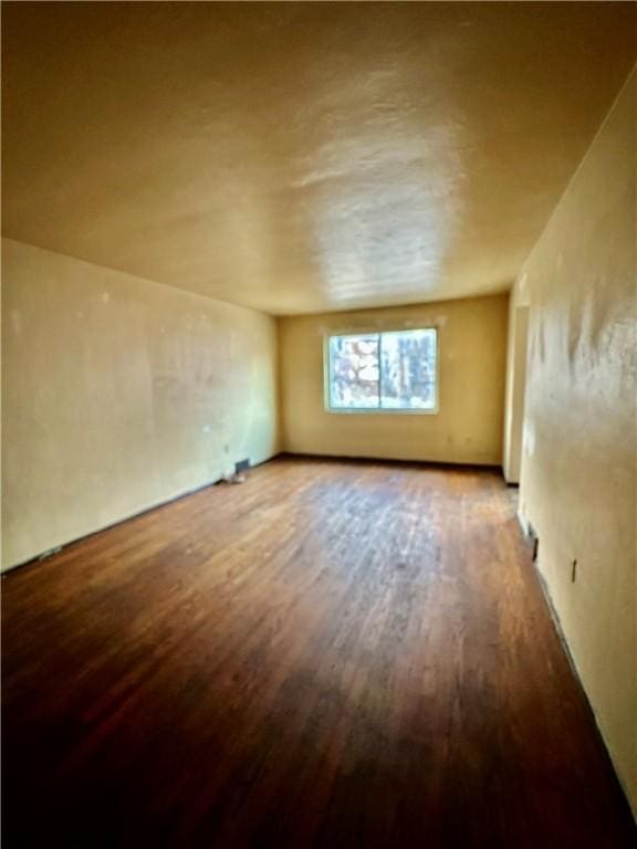 spare room featuring wood finished floors