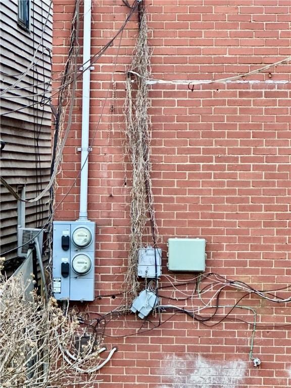 exterior details with electric meter and brick siding