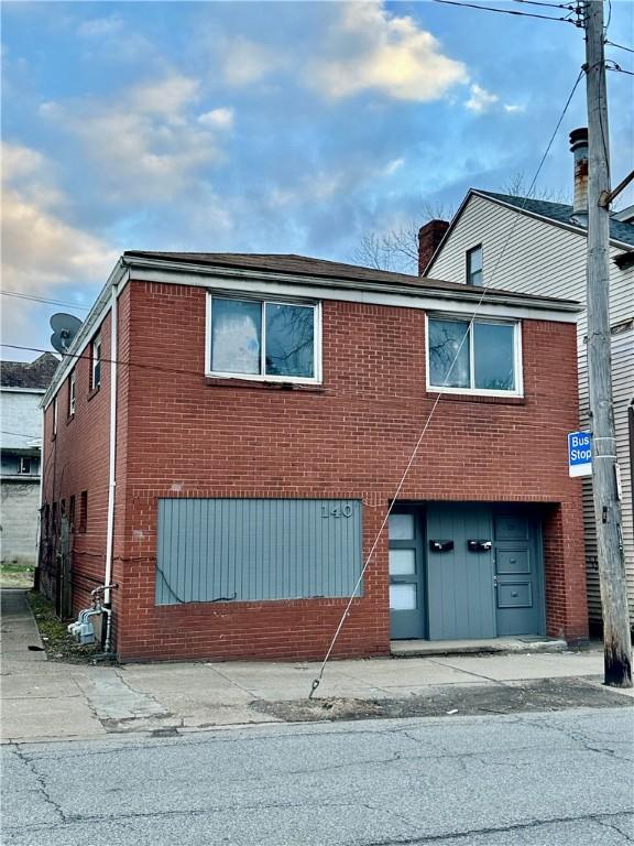 multi unit property with brick siding and a chimney