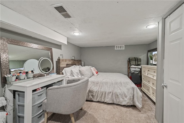 bedroom with visible vents and carpet flooring