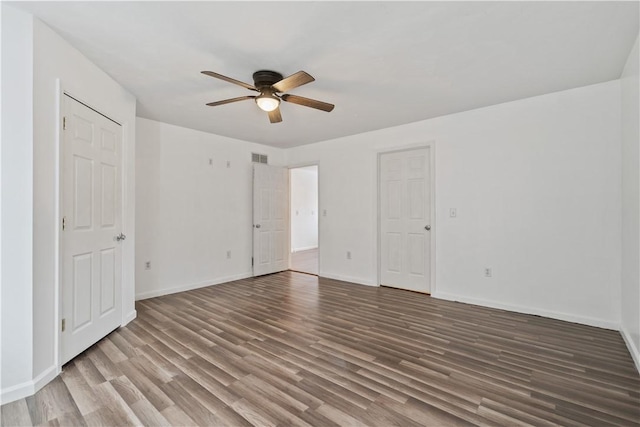 unfurnished bedroom with ceiling fan, wood finished floors, visible vents, and baseboards