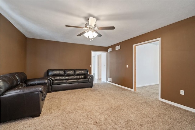 living room featuring carpet floors, visible vents, baseboards, and a ceiling fan