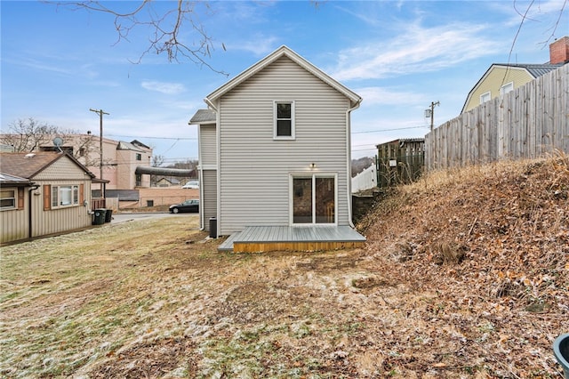 rear view of house with fence