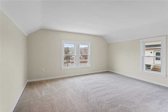 bonus room with lofted ceiling, carpet, and baseboards