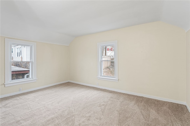 additional living space featuring vaulted ceiling, carpet floors, and baseboards