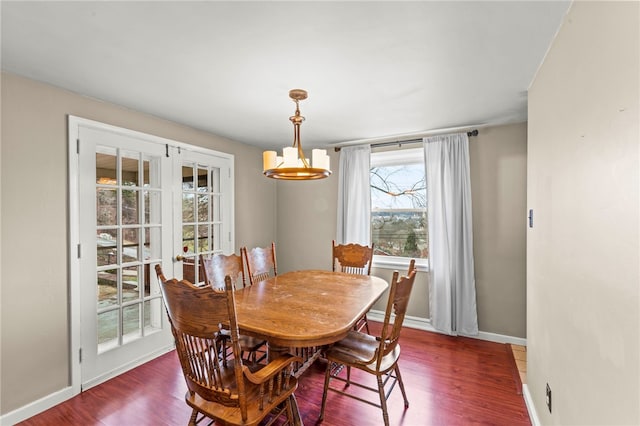 dining room with baseboards and wood finished floors