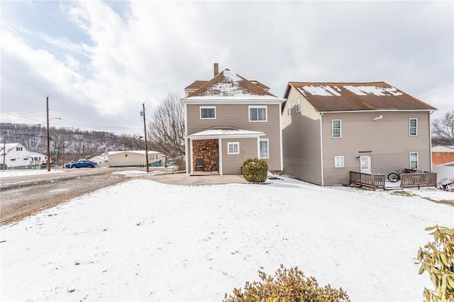 view of snow covered rear of property