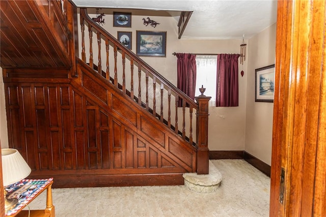 stairway featuring baseboards