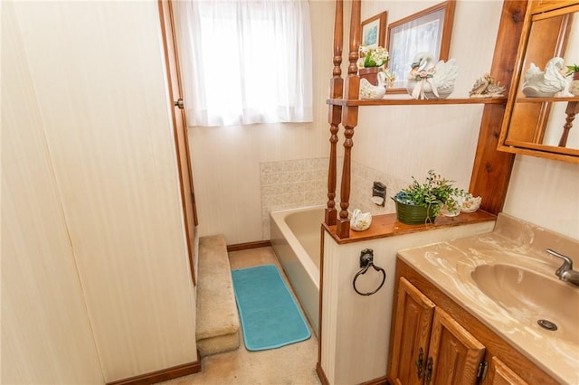 full bathroom featuring a garden tub and vanity