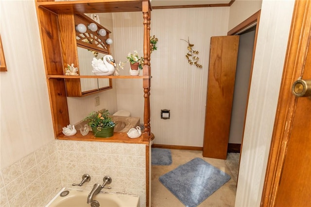 full bathroom with a garden tub and baseboards