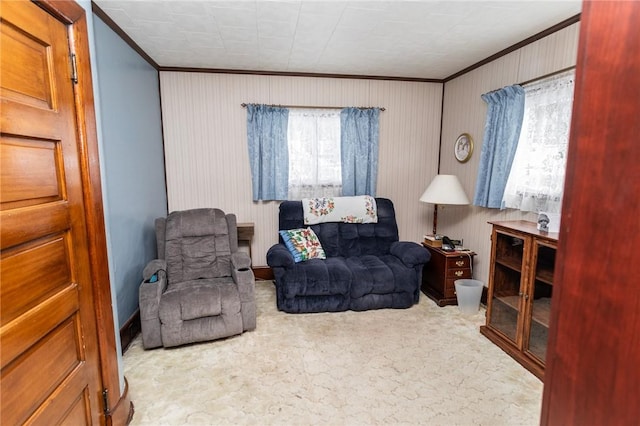 sitting room featuring ornamental molding and carpet flooring