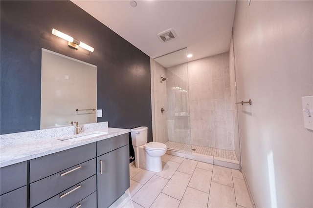 full bathroom with visible vents, tiled shower, toilet, tile patterned floors, and vanity