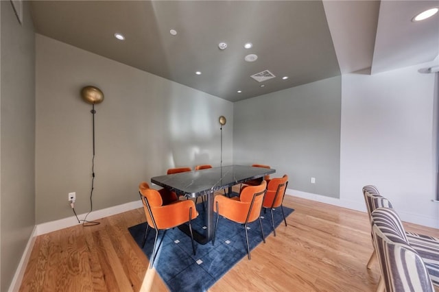 dining room with light wood-type flooring, baseboards, visible vents, and recessed lighting