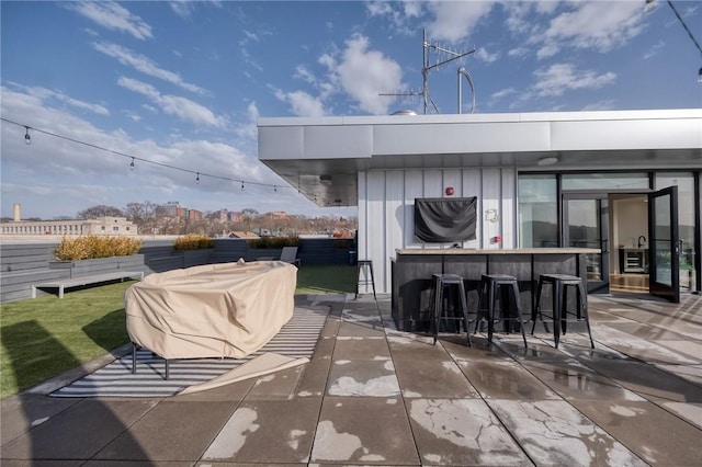 view of patio with outdoor dry bar and area for grilling