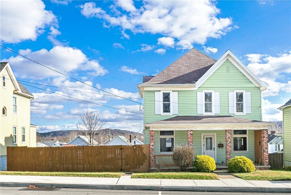 216 S 4th St, Youngwood, PA 15697 - view of front of house featuring a porch and a fenced front yard