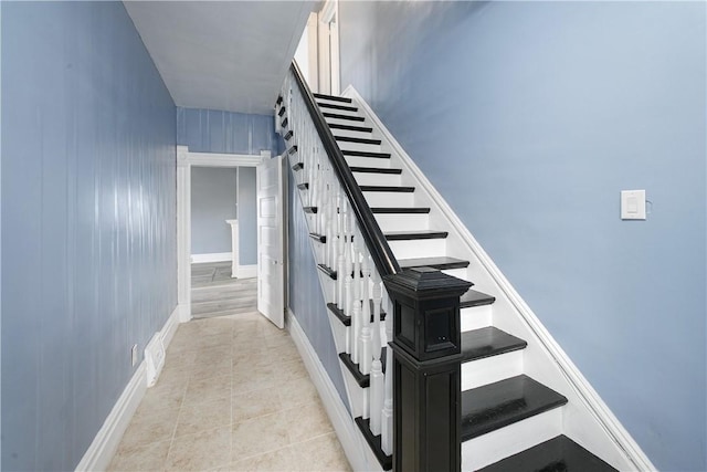 stairs with tile patterned flooring and baseboards