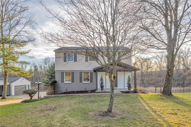 view of front facade featuring a porch, an outdoor structure, and a front lawn