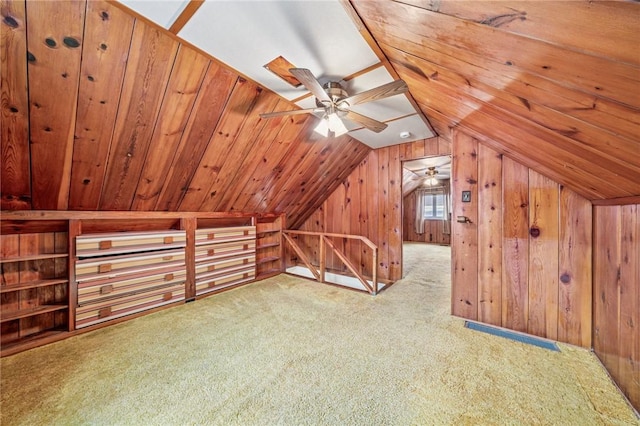 bonus room with carpet floors, wood ceiling, wooden walls, and vaulted ceiling