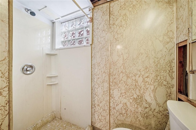 full bathroom featuring walk in shower and toilet