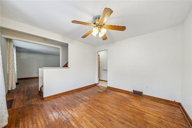 unfurnished room featuring baseboards, visible vents, ceiling fan, and hardwood / wood-style floors