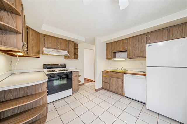 kitchen featuring white appliances, light countertops, under cabinet range hood, open shelves, and a sink