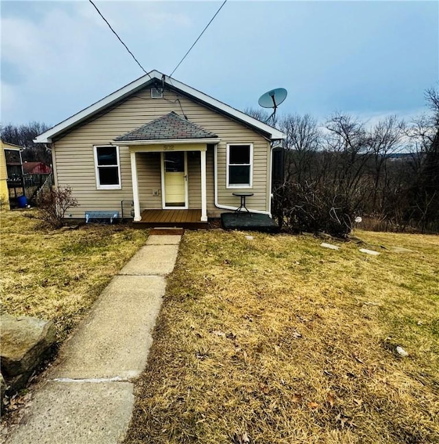 bungalow featuring a front yard and covered porch