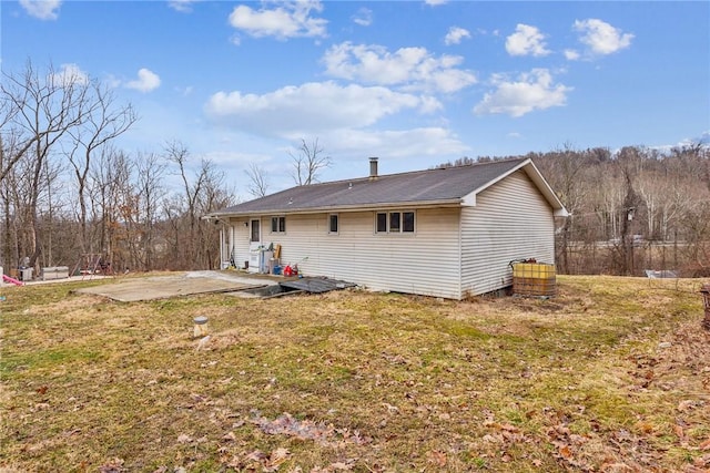 back of property with a lawn and a patio area