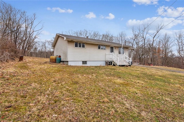 rear view of property featuring a yard