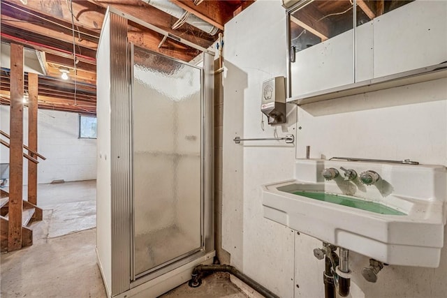 bathroom featuring a stall shower and unfinished concrete floors