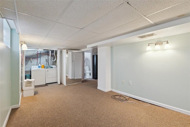 finished basement with baseboards, carpet floors, visible vents, and washer and dryer