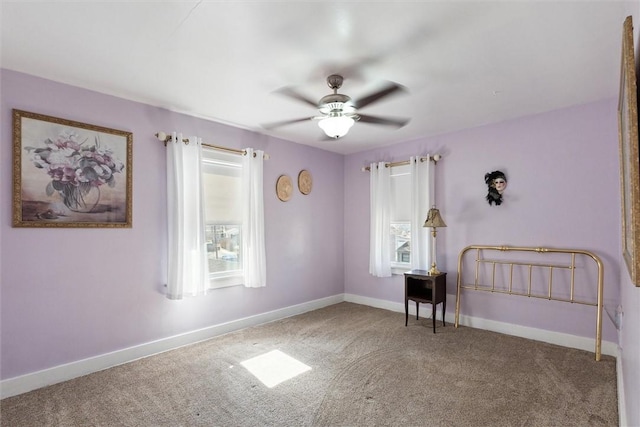 unfurnished bedroom featuring ceiling fan, baseboards, and carpet flooring