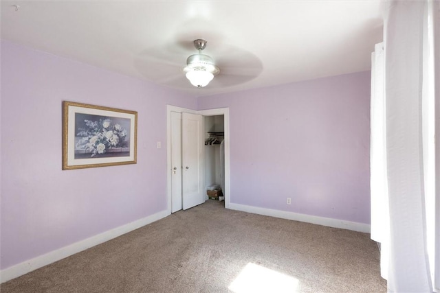 unfurnished bedroom featuring carpet floors, a closet, ceiling fan, and baseboards