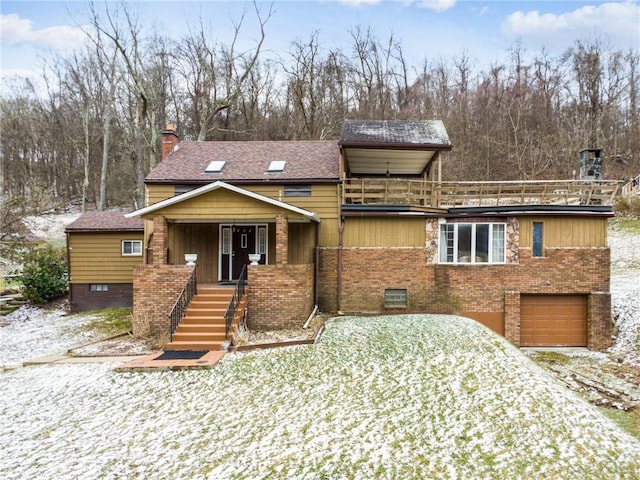 view of front of house with stairway, a balcony, a garage, and brick siding