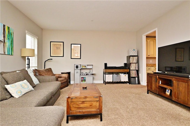 carpeted living room with baseboards