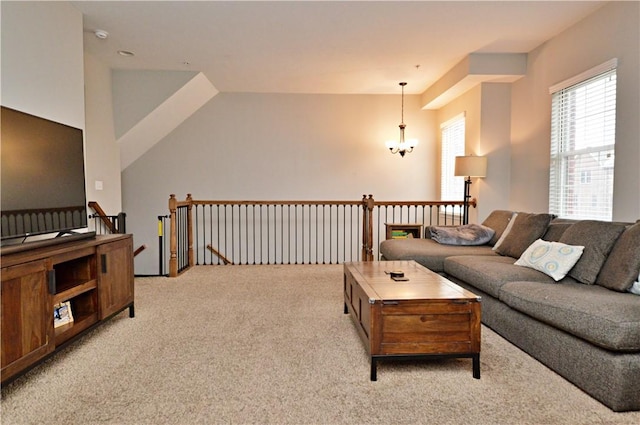 living area featuring a chandelier and carpet