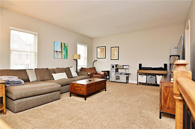 living area featuring light carpet and a wealth of natural light