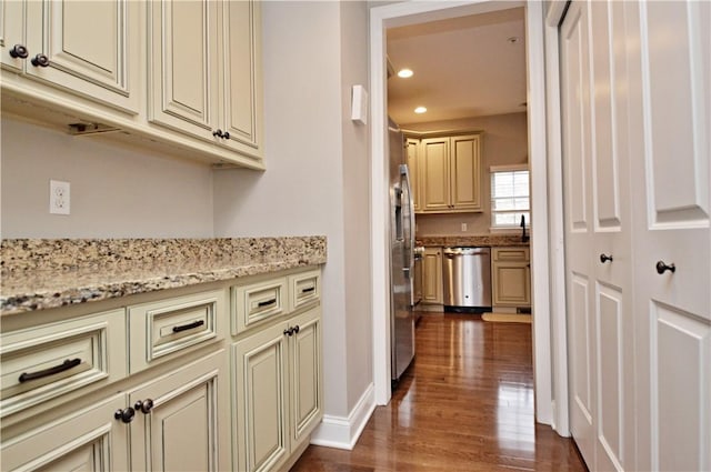 hall featuring recessed lighting, dark wood-style flooring, a sink, and baseboards