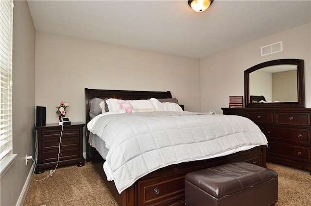 bedroom featuring baseboards, visible vents, and carpet flooring