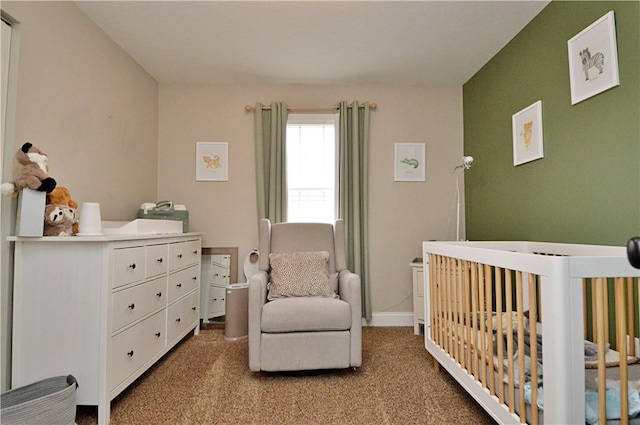 bedroom with a nursery area, light colored carpet, and baseboards