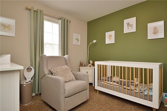 carpeted bedroom featuring a crib